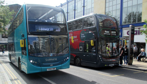 Sapphire Bus 4411 passing National Express
                    WM Bus 6729